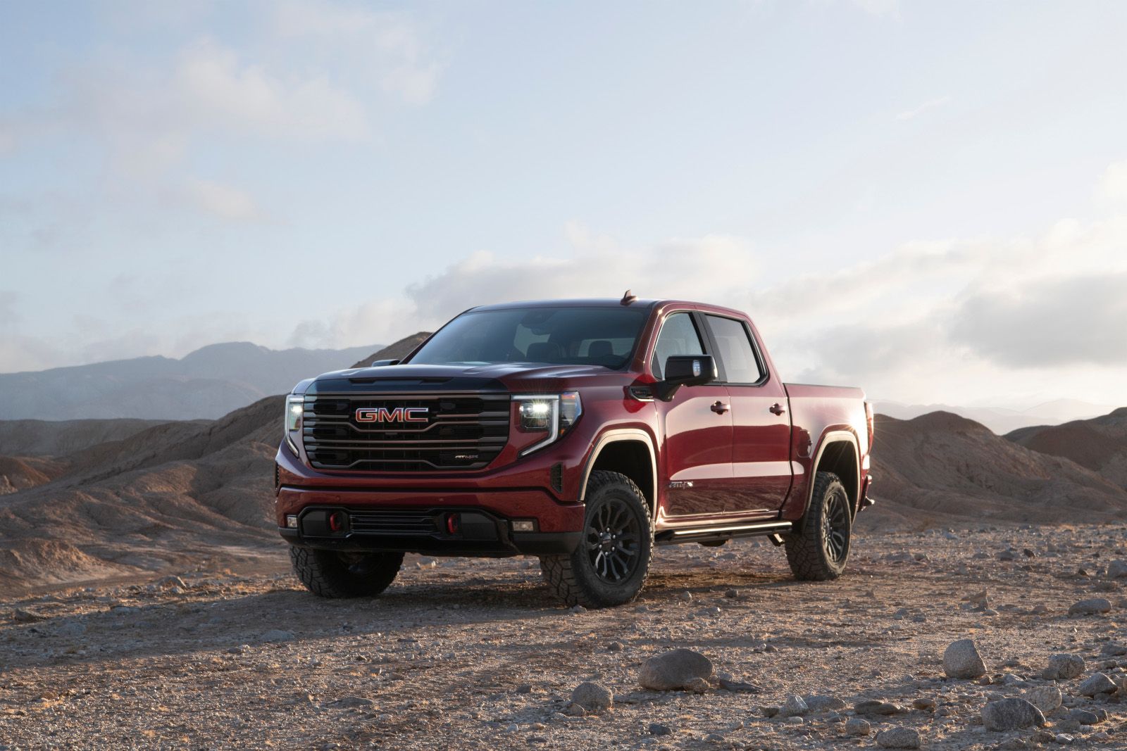 2025 GMC Sierra AT4X - a red 2025 GMC Sierra AT4X parked in a desert landscape - City GM - GMC car dealership in Toronto, Ontario