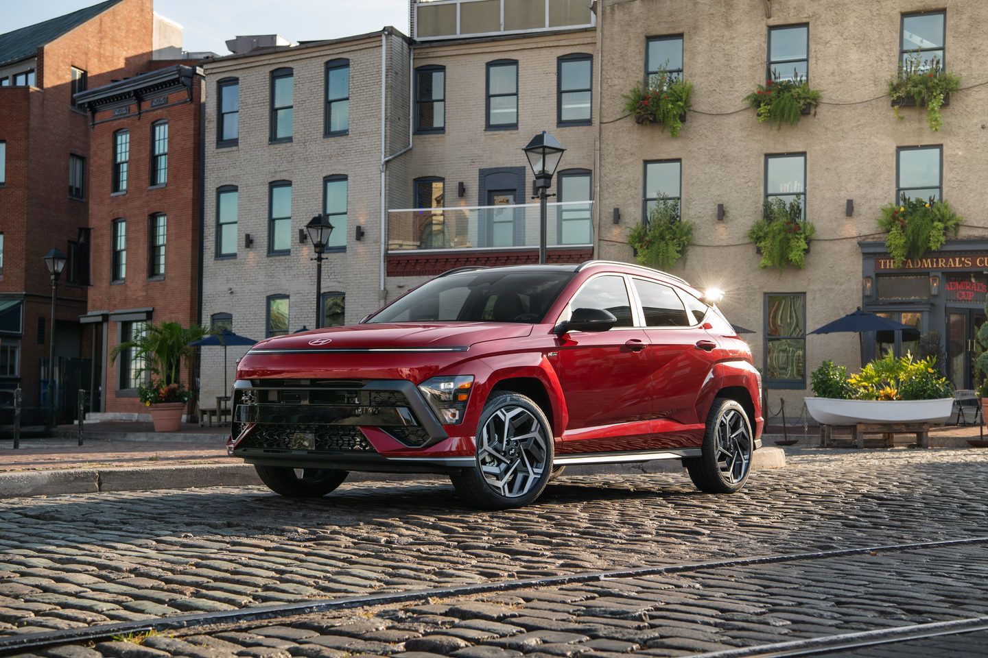2025 Hyundai Kona - a red 2025 Hyundai Kona N Line parked on a cobblestone street - Cooksville Hyundai - Hyundai car dealership in Mississauga, Ontario