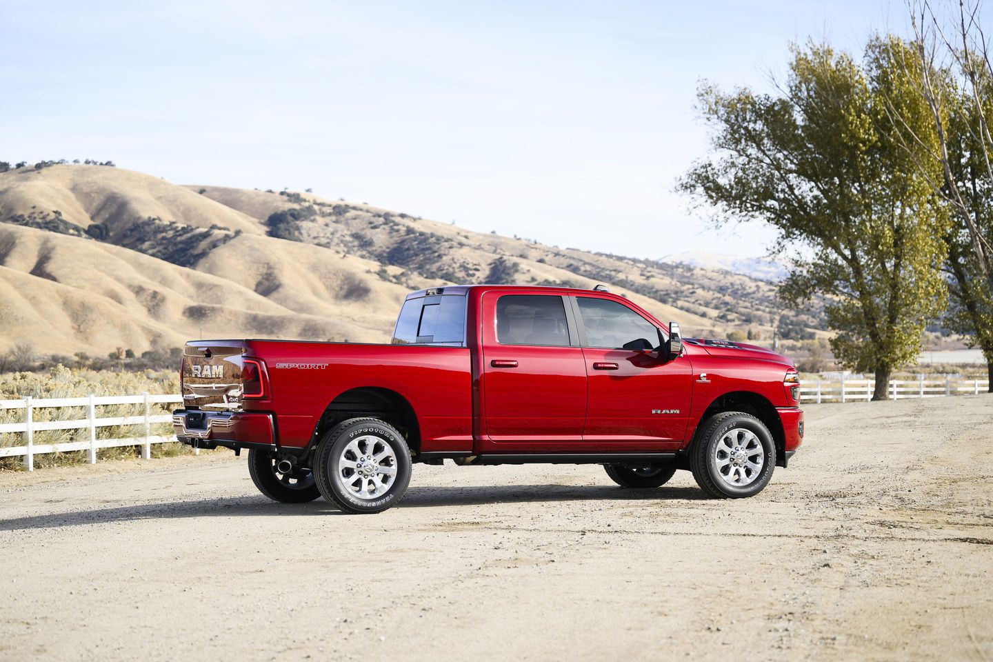 2025 Ram 2500 rear three-quarter view of the red truck parked on a dirt road - Cooksville Dodge - Ram car dealership in Mississauga, Ontario