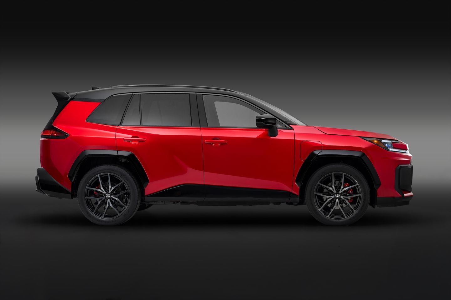 2025 Toyota RAV4 side profile view of a red 2025 Toyota RAV4 GR Sport in a studio - Goderich Toyota - Toyota car dealership in Goderich, Ontario