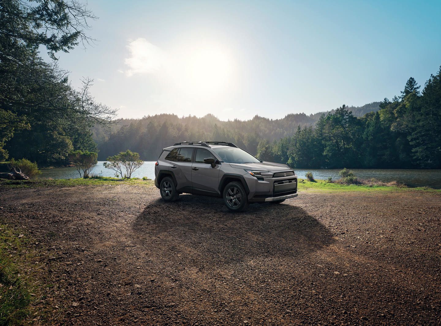 2025 Toyota RAV4 a grey 2025 Toyota RAV4 Woodland parked on a gravel path near a lake - Goderich Toyota - Toyota car dealership in Goderich, Ontario