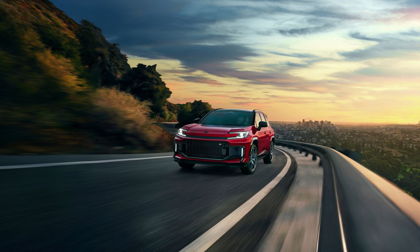 2026 Toyota RAV4 - a red Toyota RAV4 driving on a winding highway at sunset - Orangeville Toyota - Toyota car dealership in Orangeville, Ontario