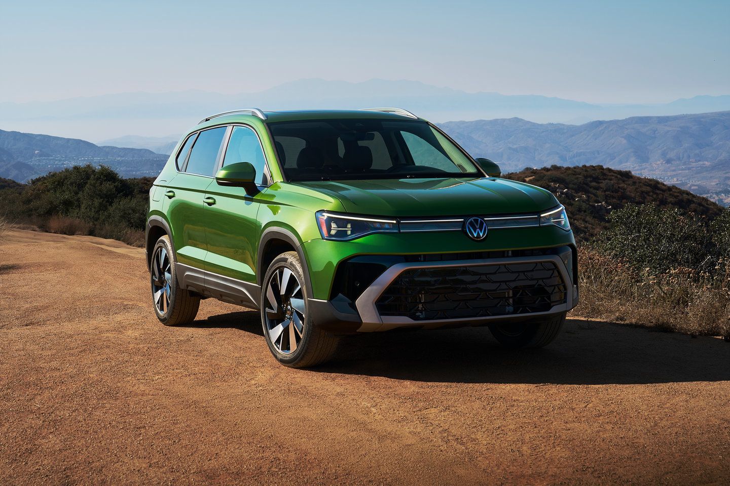 2025 Volkswagen Taos - front three-quarter view of a green 2025 Volkswagen Taos on a dirt path - Humberview Volkswagen - Volkswagen car dealership in Toronto, Ontario