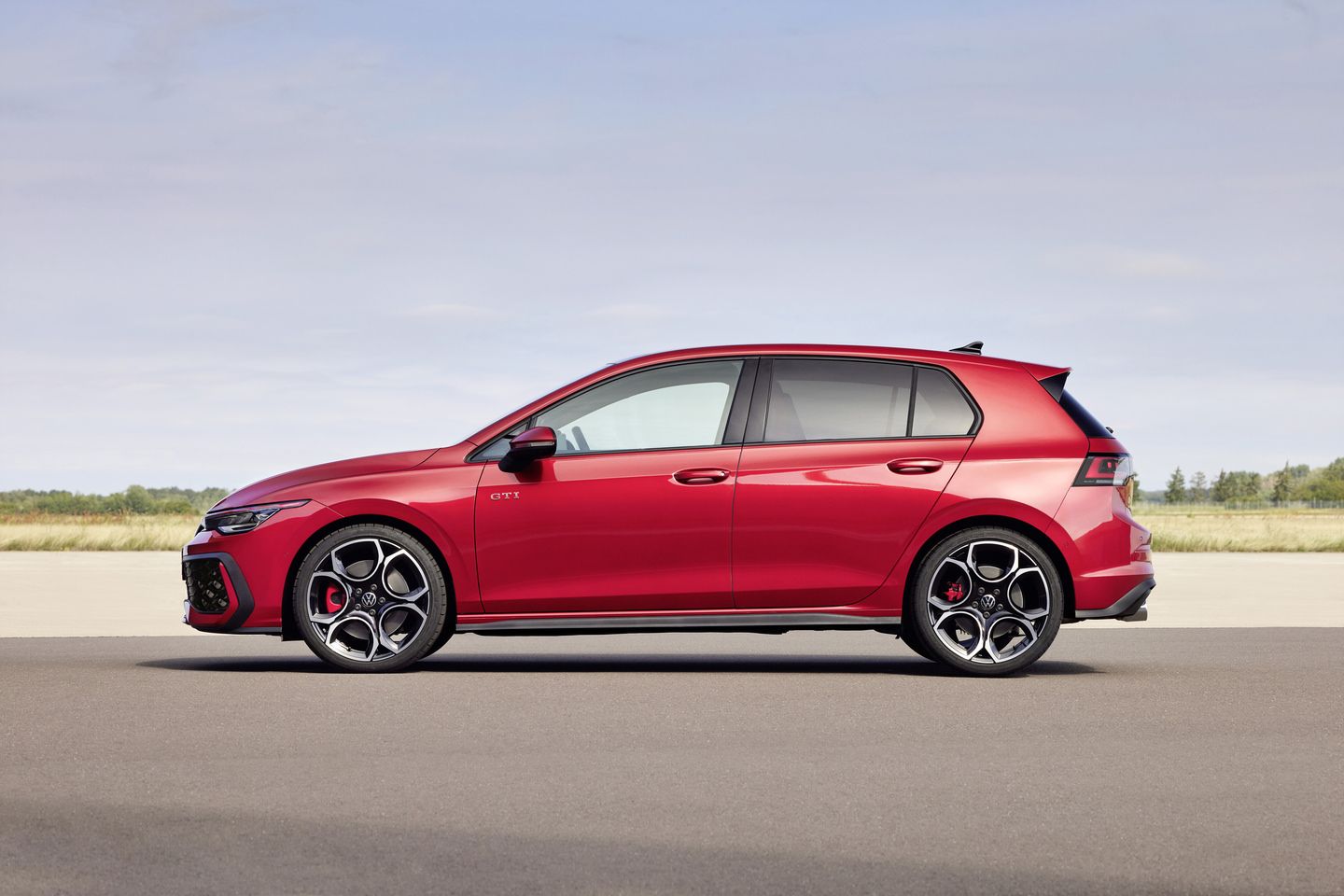 2025 Volkswagen Golf GTI - Side profile view of a red 2025 Volkswagen Golf GTI - Volkswagen MidTown - Volkswagen car dealership in Toronto, Ontario