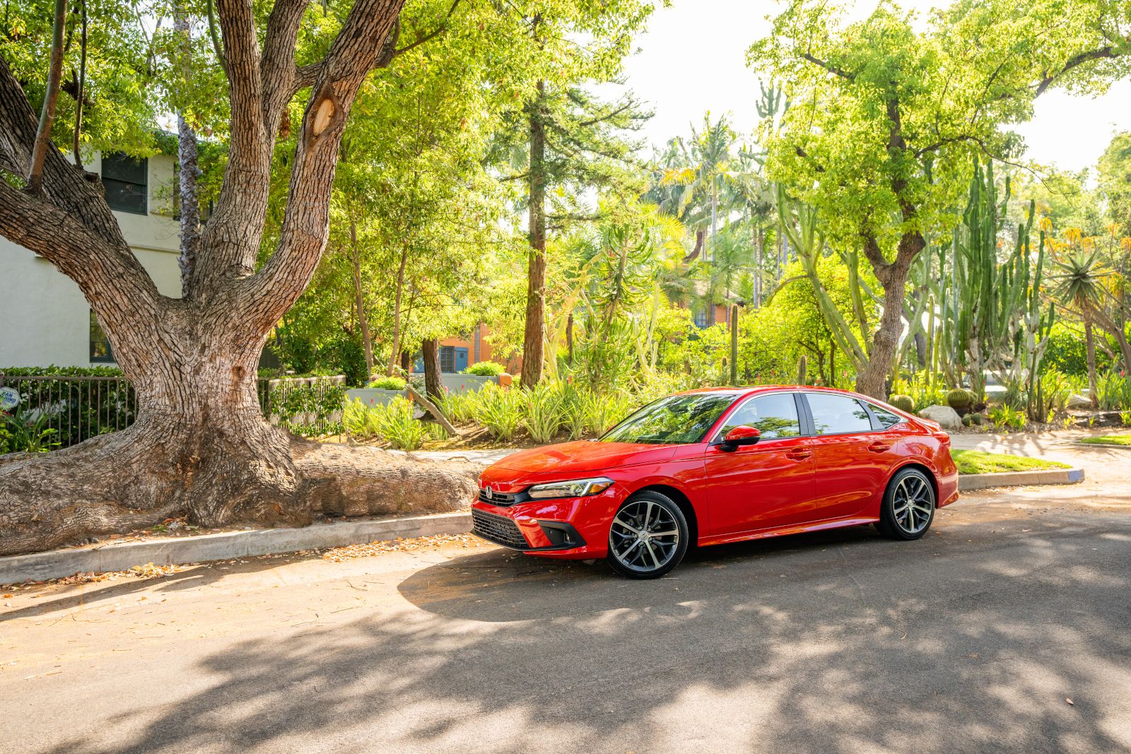 2022 Honda Civic - a bright red 2022 Honda Civic parked under a tree - AutoPark Barrie pre-owned car dealer in Innisfil, Ontario