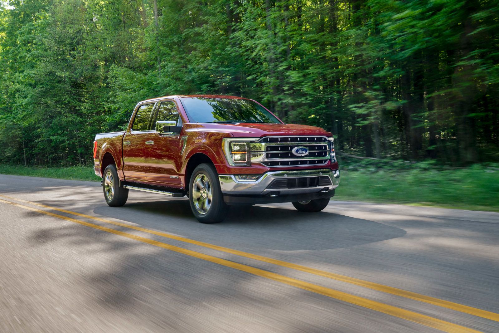 2020 Ford F-150 - a red Ford F-150 driving on a country road - AutoPark Barrie pre-owned car dealer in Innisfil, Ontario