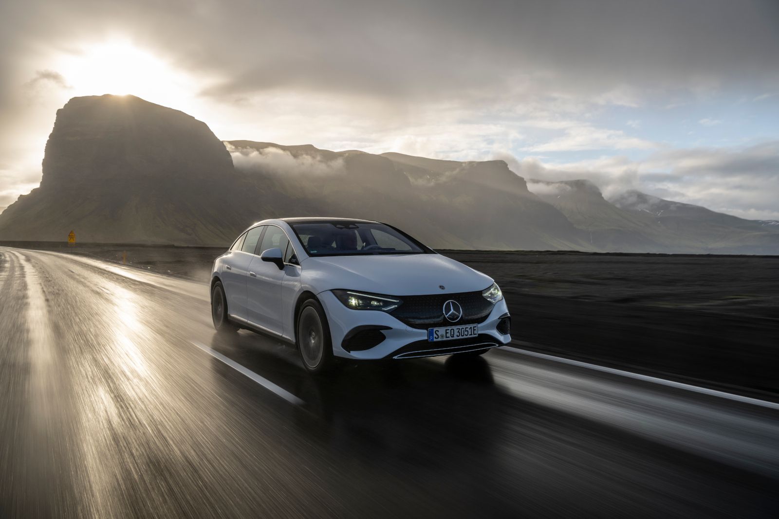 2025 Mercedes-Benz EQE Sedan - a white sedan driving on a wet, scenic road - Humberview Group - new car dealerships in Ontario