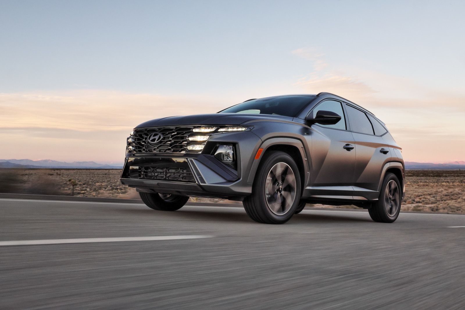 2025 Hyundai Tucson - a grey SUV driving on a highway - Humberview Group - new car dealerships in Ontario