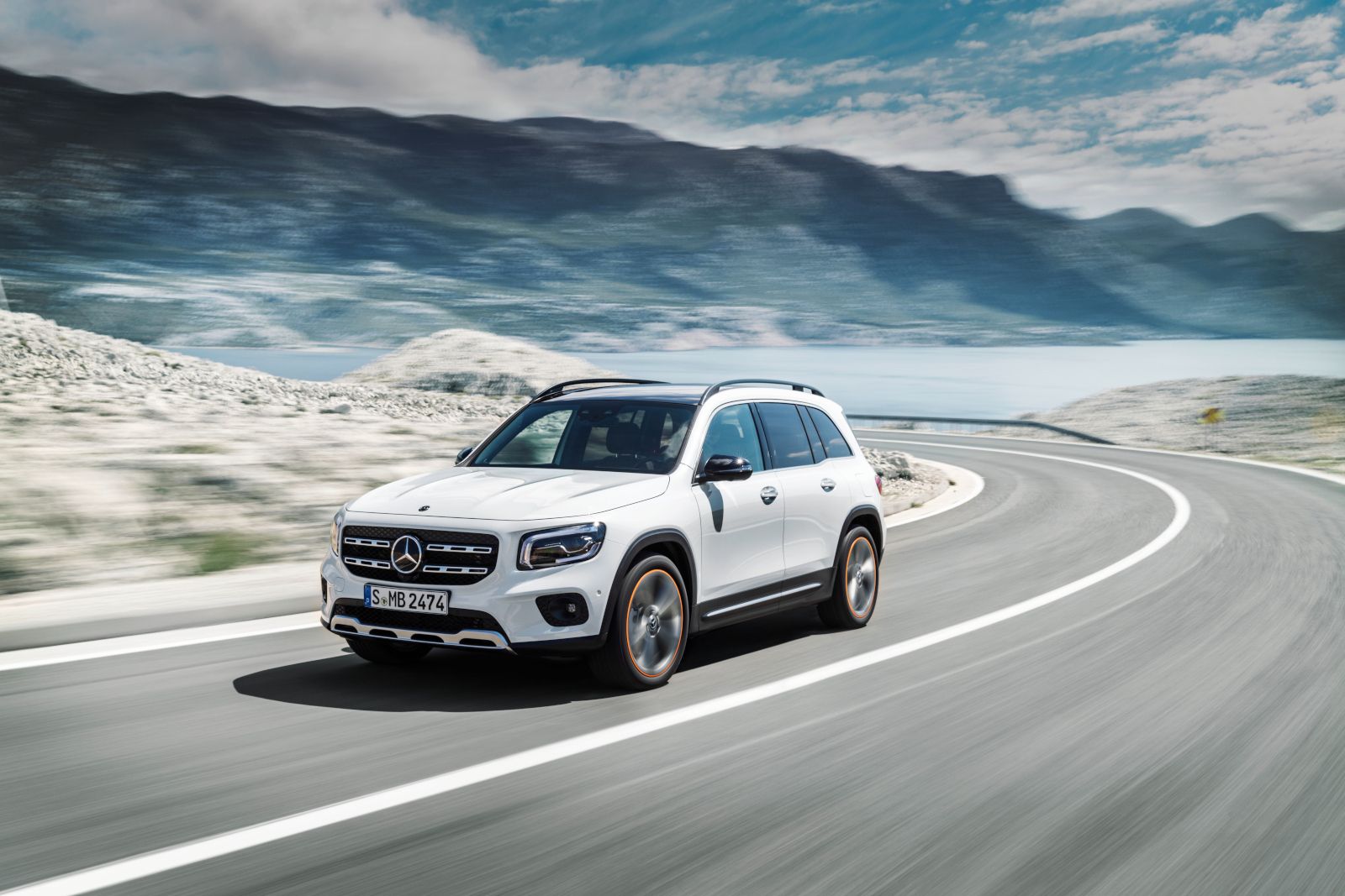 2025 Mercedes-Benz GLB - a white 2025 Mercedes-Benz GLB driving on a winding road - Mercedes-Benz Brampton - Mercedes-Benz car dealership in Brampton, ON