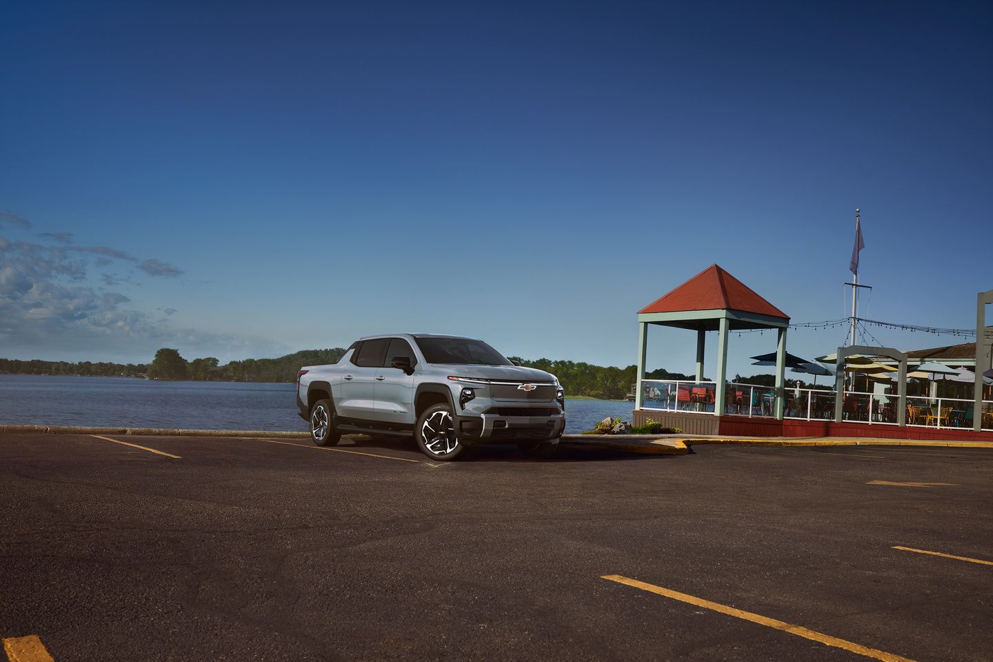 2025 Chevrolet Silverado EV - a silver 2025 Chevrolet Silverado EV parked in a lot by the water - Applewood Chevrolet Buick GMC - Chevrolet car dealership in Mississauga, ON