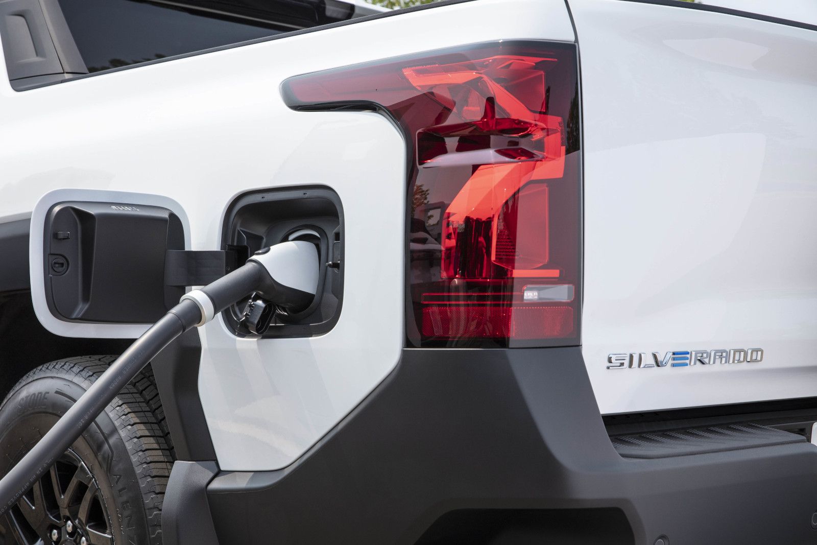 2025 Chevrolet Silverado EV - close-up of a white 2025 Chevrolet Silverado EV's charging port - Applewood Chevrolet Buick GMC - Chevrolet car dealership in Mississauga, ON
