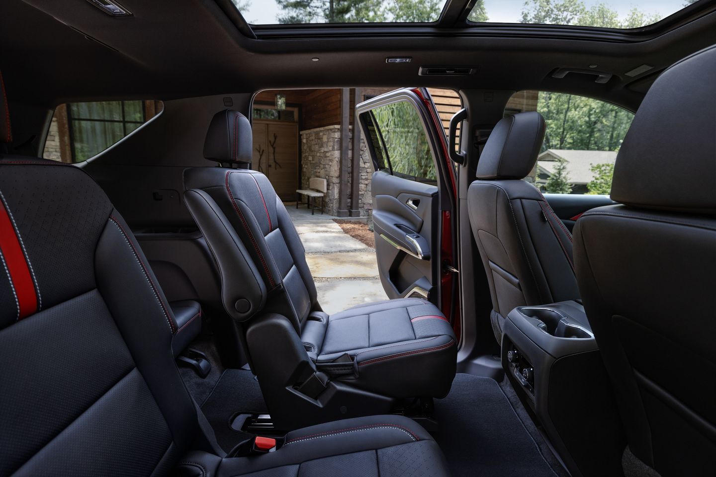 2025 Chevrolet Traverse - interior view of the second-row captain's chairs in a 2025 Chevrolet Traverse, showing black leather seats with red accents - City Chevrolet Buick GMC - new car dealerships in Ontario