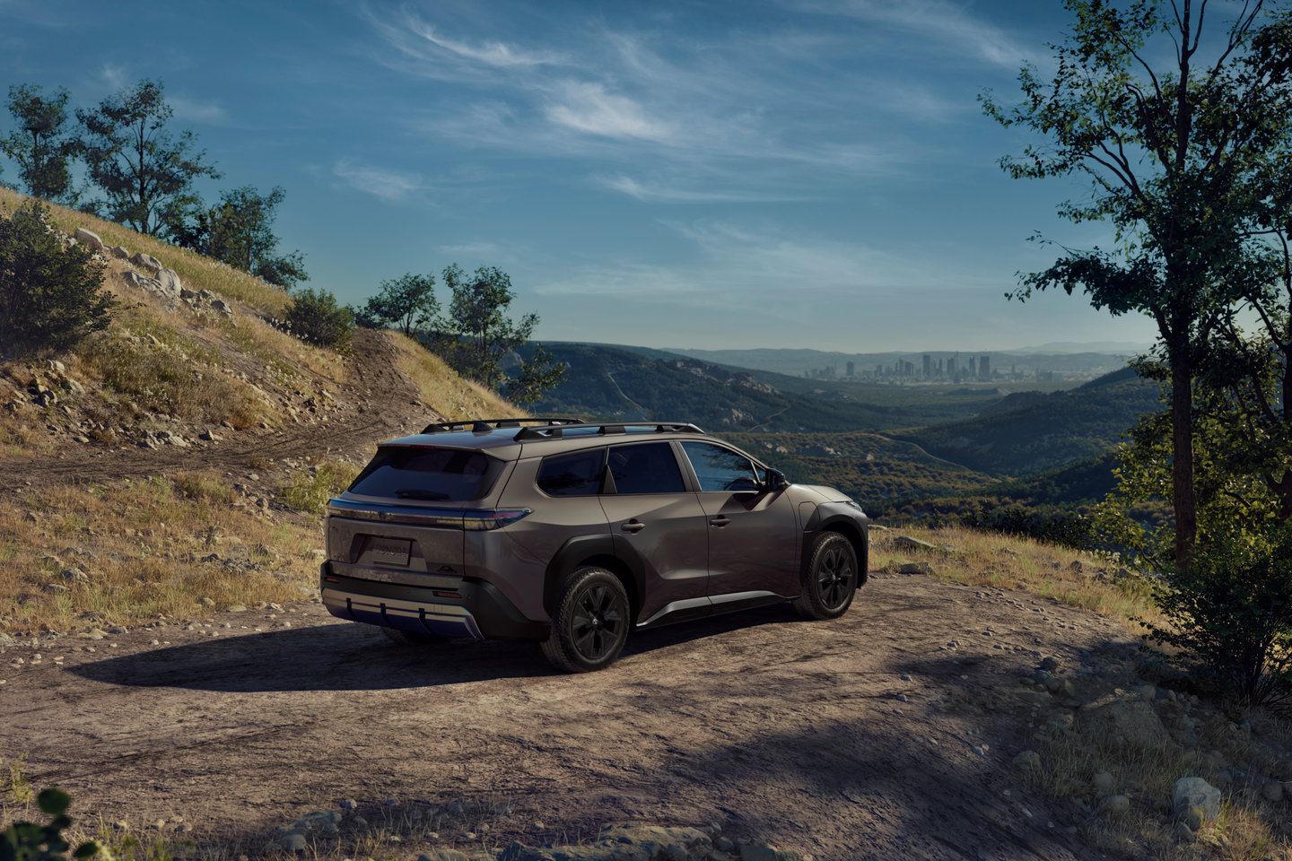 2026 Toyota bZ Woodland rear view of a dark gray bZ Woodland parked on a dirt road in the mountains - Goderich Toyota - new car dealerships in Ontario