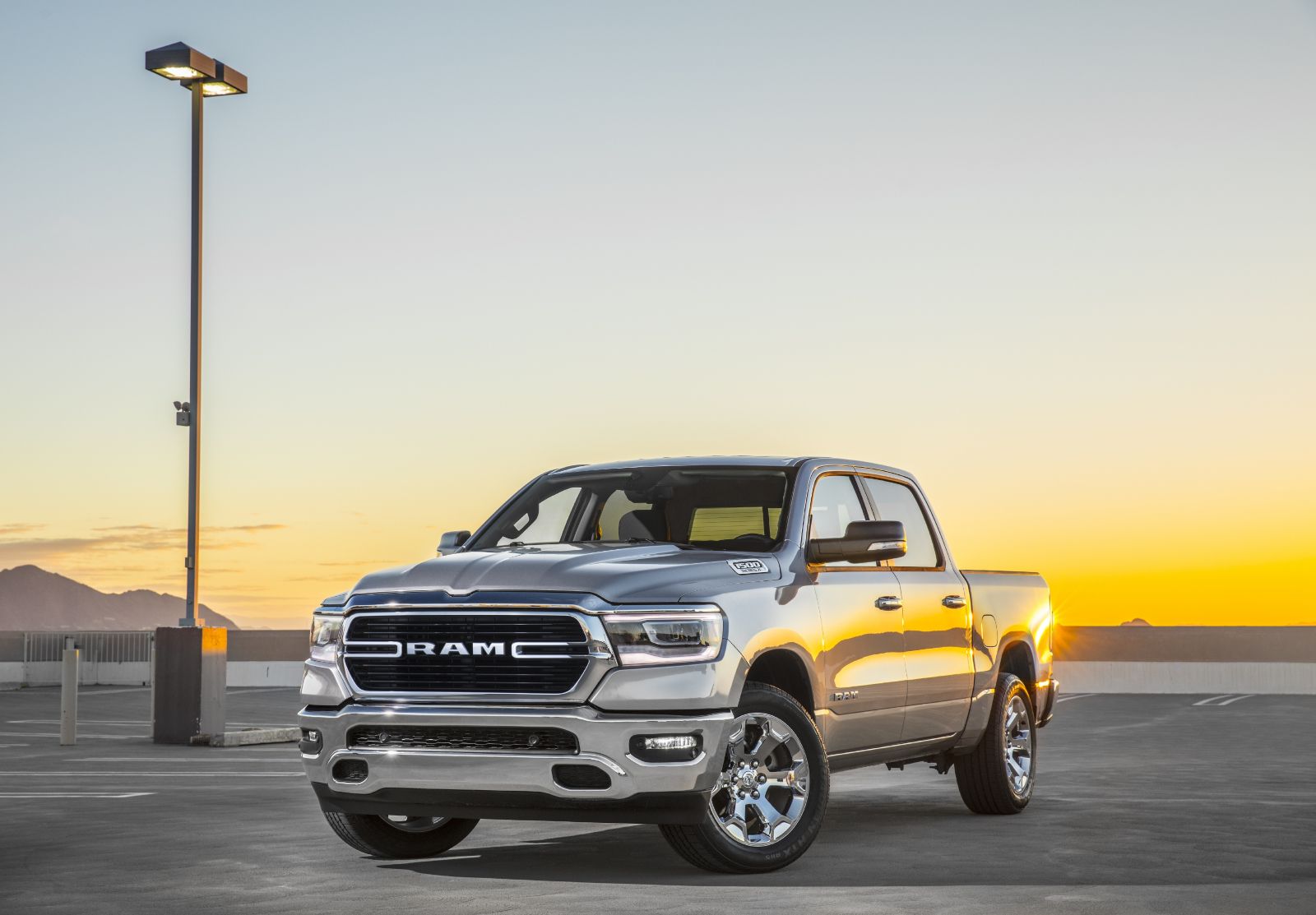 2025 Ram 1500 - a silver Laramie model parked on a rooftop parking lot at sunset - AutoPark Barrie - Pre-owned car dealership in Innisfil, Ontario