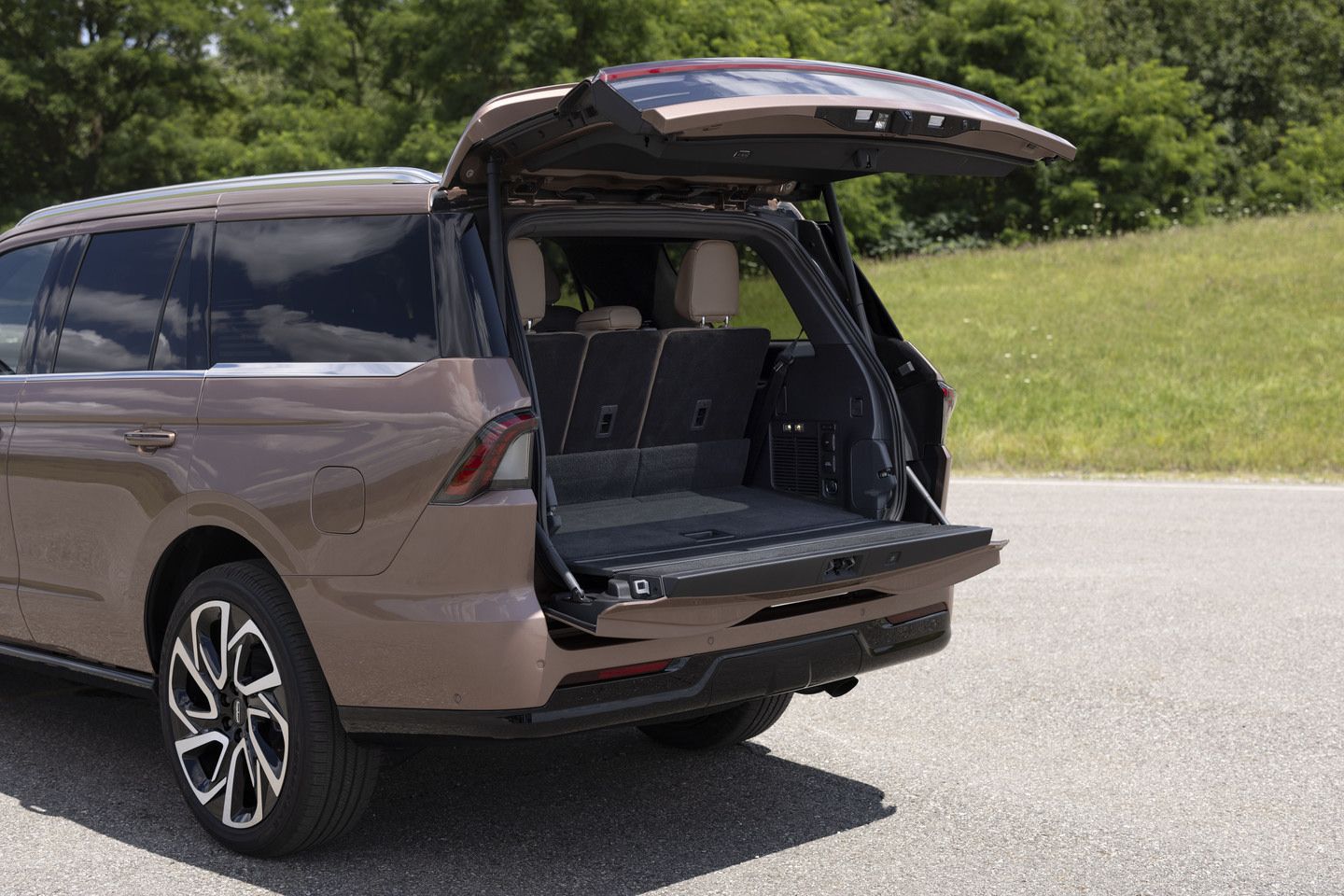 2025 Lincoln Navigator - rear view of the bronze SUV with the liftgate open, showing the spacious cargo area - Mayfield Lincoln - New car dealership in Brampton, Ontario