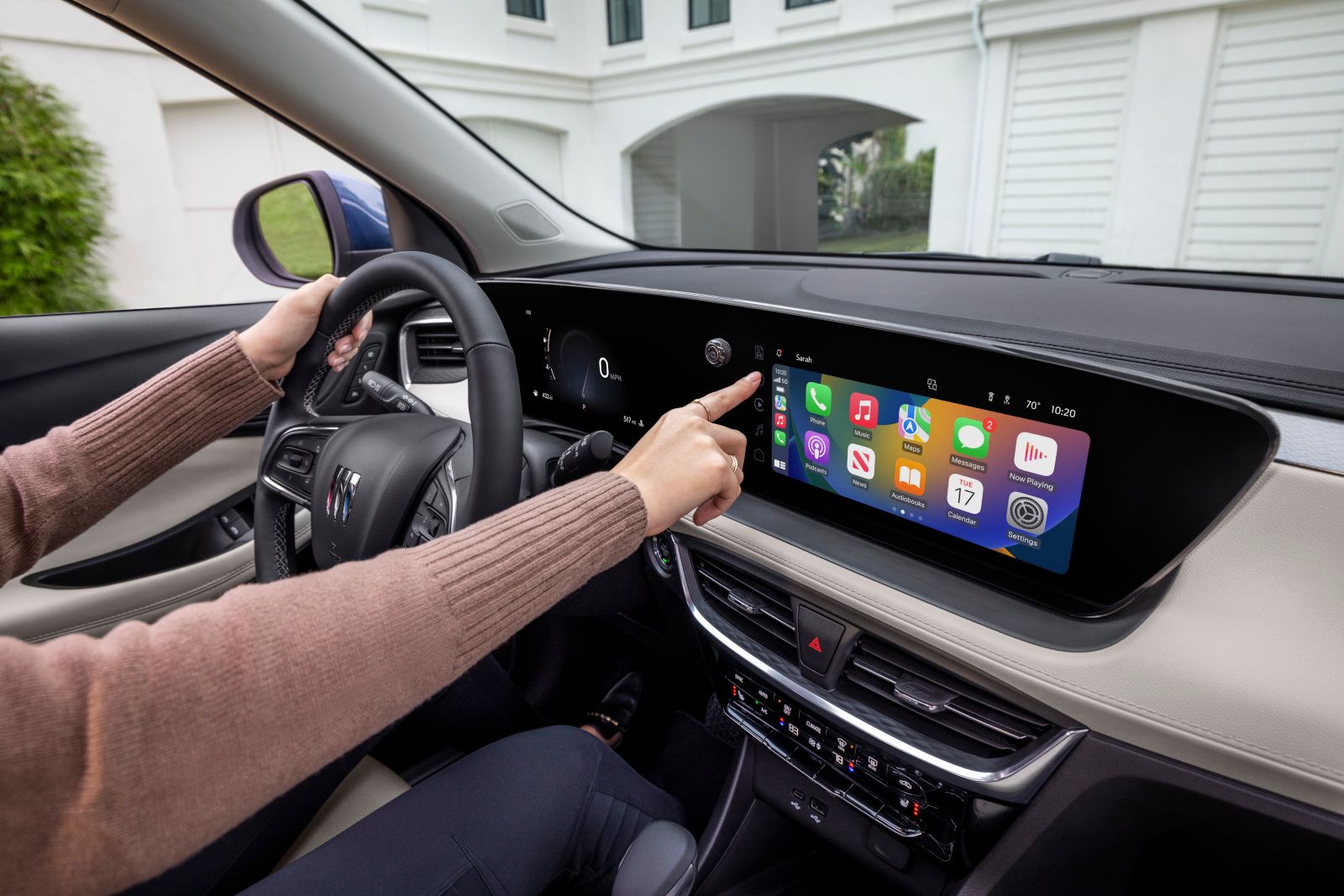 2025 Buick Encore GX - A driver interacting with the infotainment screen of a 2025 Buick Encore GX - Applewood Chevrolet, Buick, GMC - New car dealership in Mississauga, Ontario