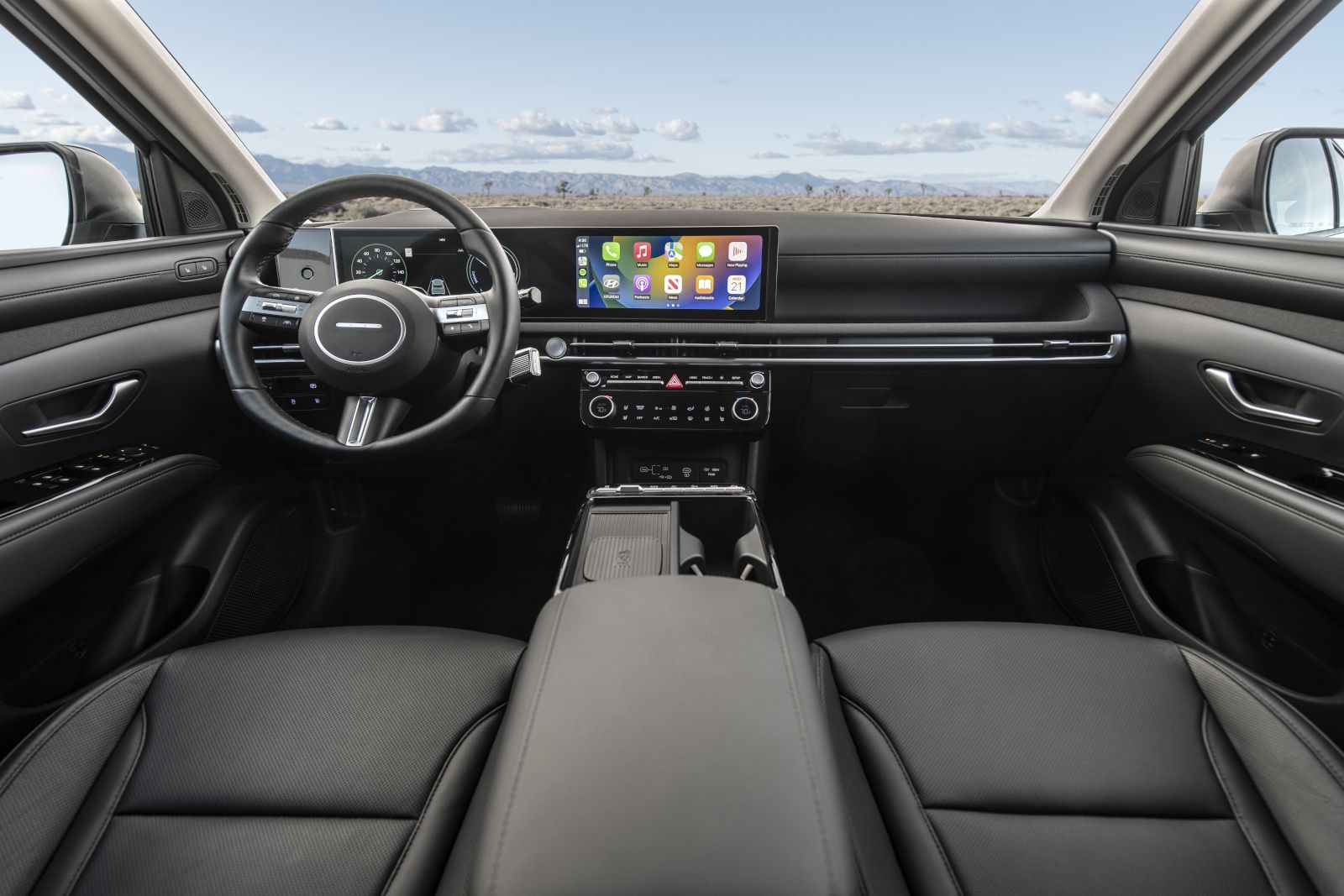 2025 Hyundai Tucson Plug-in Hybrid - Interior view of the 2025 Hyundai Tucson PHEV's black dashboard, digital display, and steering wheel - Woodstock Hyundai - New car dealership in Woodstock, Ontario