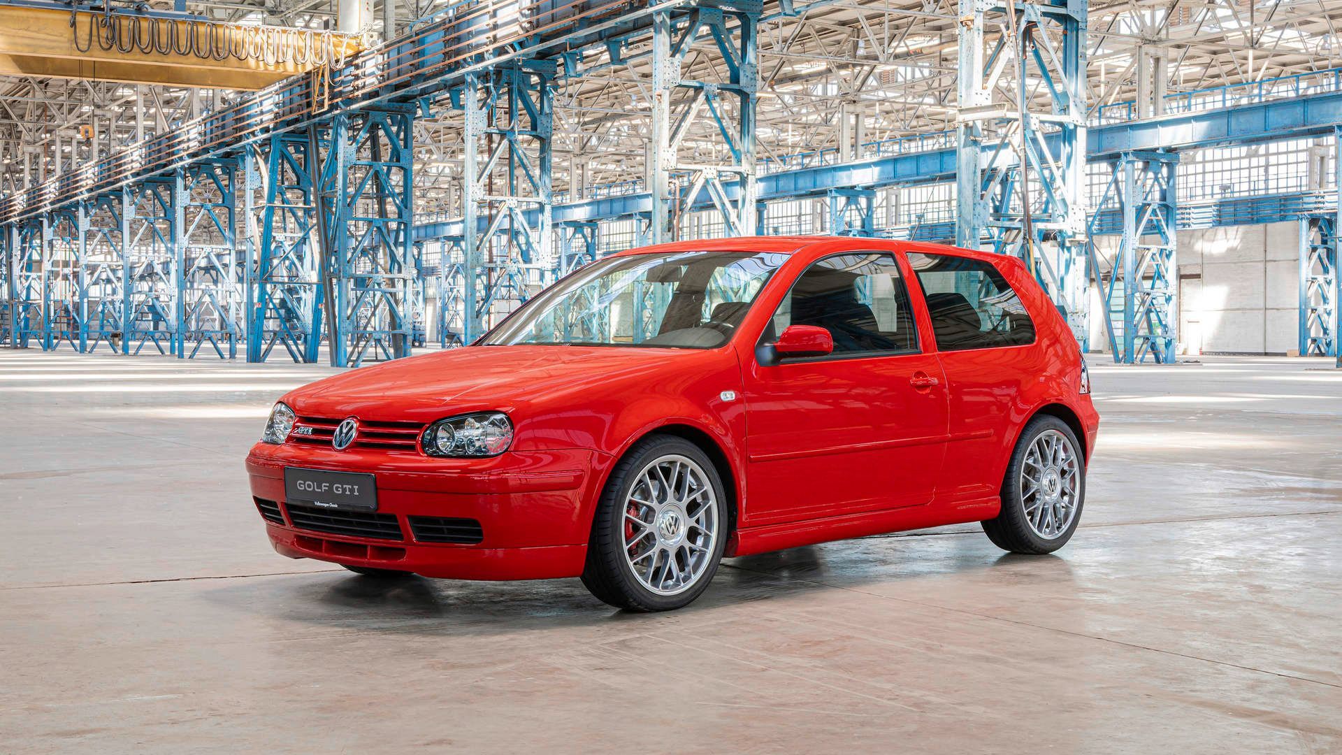 Volkswagen Golf GTI - A front three-quarter view of a red Volkswagen Golf GTI Mk.4 parked in a large industrial building - Volkswagen MidTown Toronto - New car dealership in Toronto, Ontario