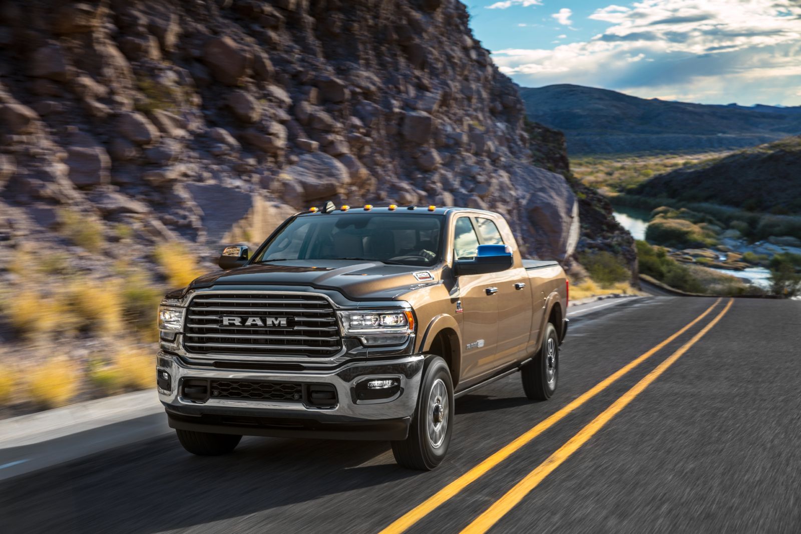 Ram 2500 - a bronze Ram 2500 driving on a winding road through a canyon - Autopark Brampton - Used car dealership in Brampton, Ontario