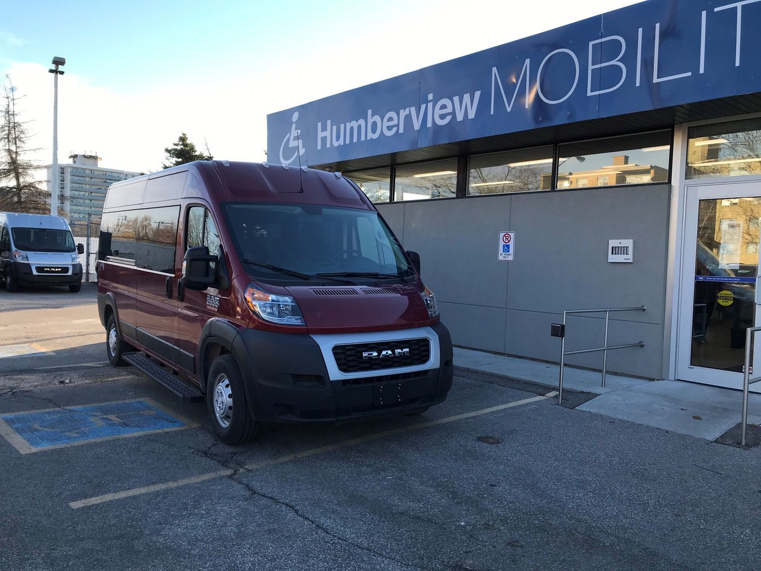 Ram ProMaster - Front-angle view of a red Ram ProMaster accessible van parked outside the Humberview Mobility dealership - Humberview Mobility - Accessible Vehicle dealership in Toronto, Ontario