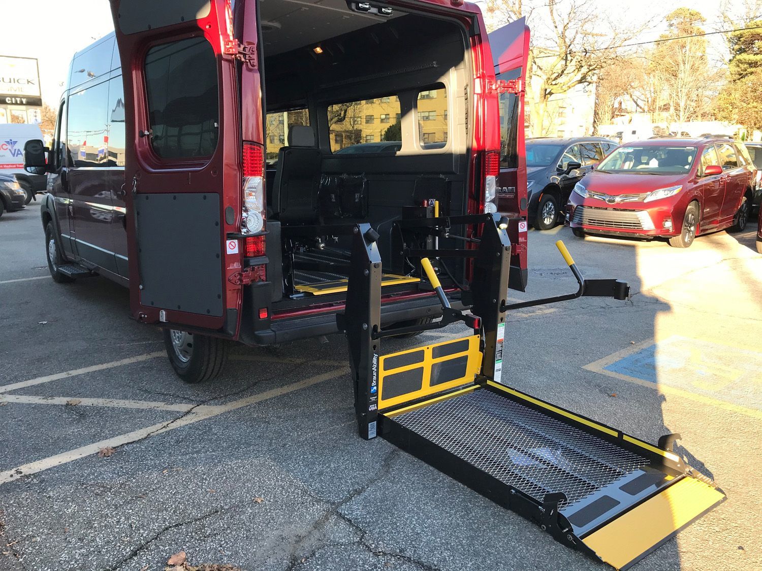 Ram ProMaster - Rear view of a red accessible Ram ProMaster van with the wheelchair lift deployed - Humberview Mobility - Accessible Vehicle dealership in Toronto, Ontario