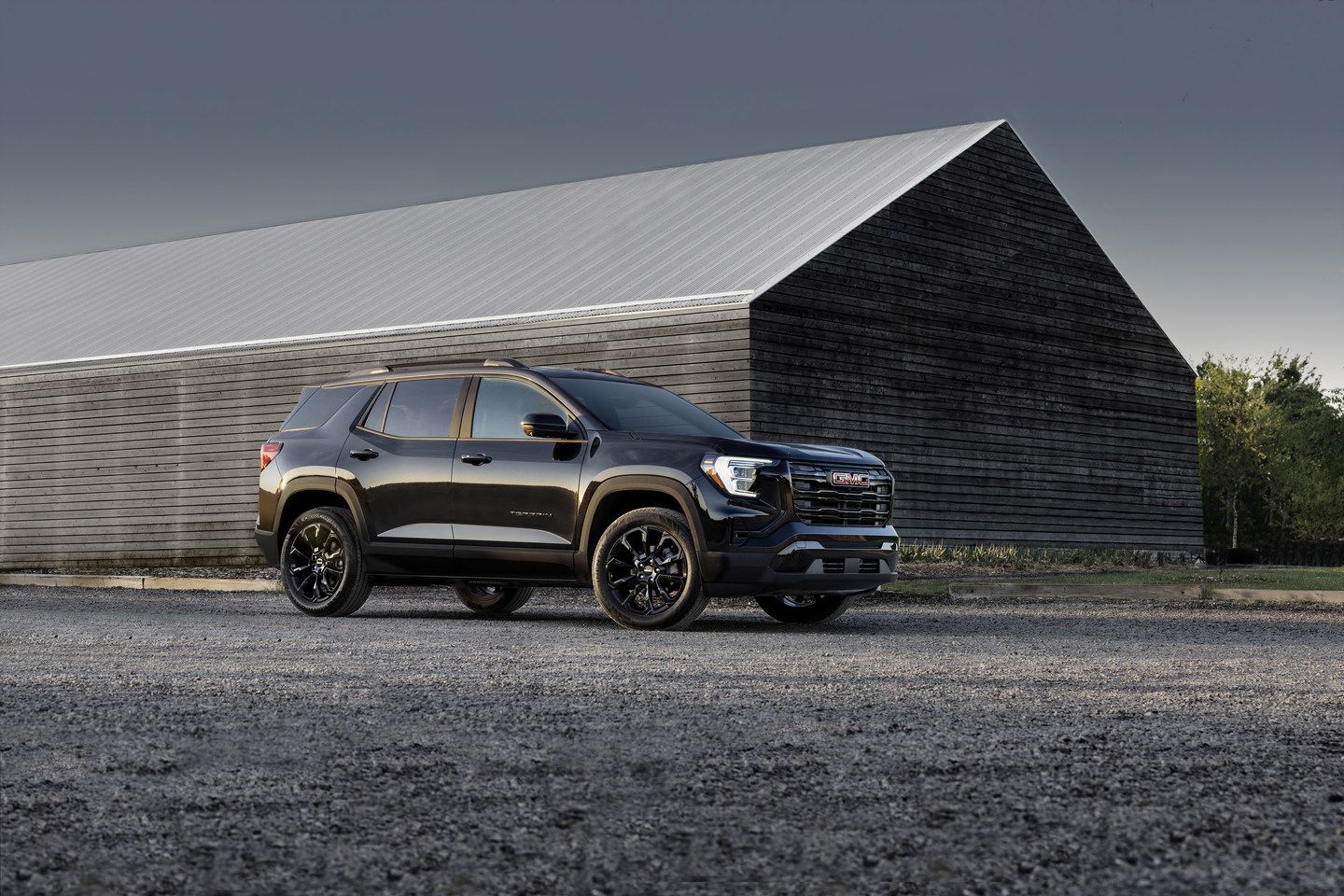 2026 GMC Terrain - Front three-quarter view of a black 2026 GMC Terrain parked in front of a modern building - Humberview Group - GMC car dealership in Ontario