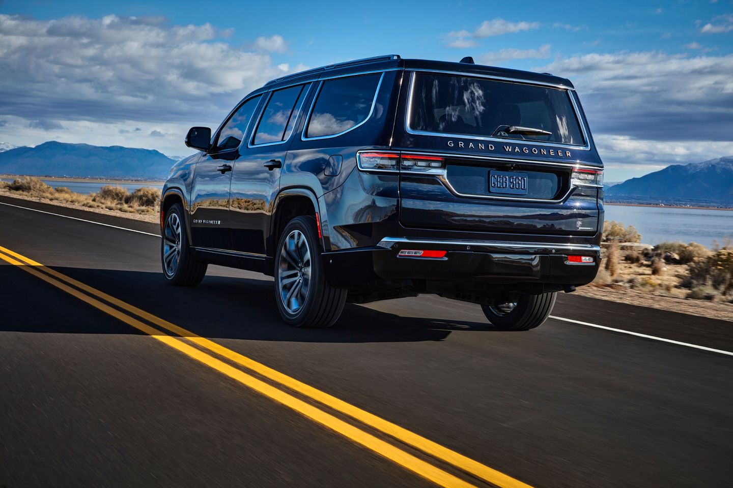2025 Jeep Grand Wagoneer - Rear three-quarter view of a black Jeep Grand Wagoneer driving on a highway - Cooksville Dodge Chrysler - New car dealership in Mississauga, Ontario