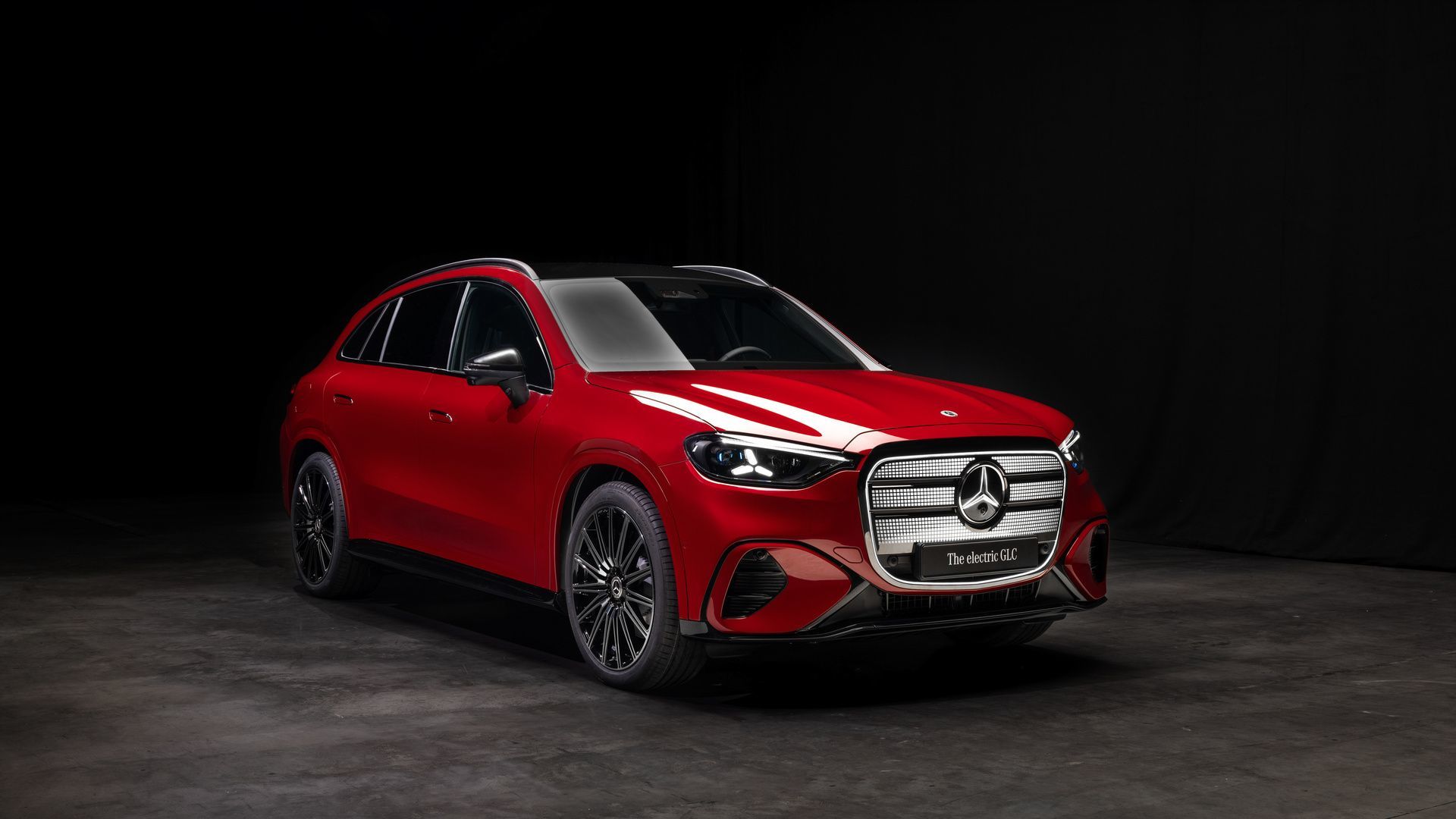 2026 Mercedes-Benz GLC with EQ Technology - A red 2026 Mercedes-Benz GLC with EQ Technology shown from the front in a studio setting - Mercedes-Benz Brampton - New car dealership in Brampton, Ontario