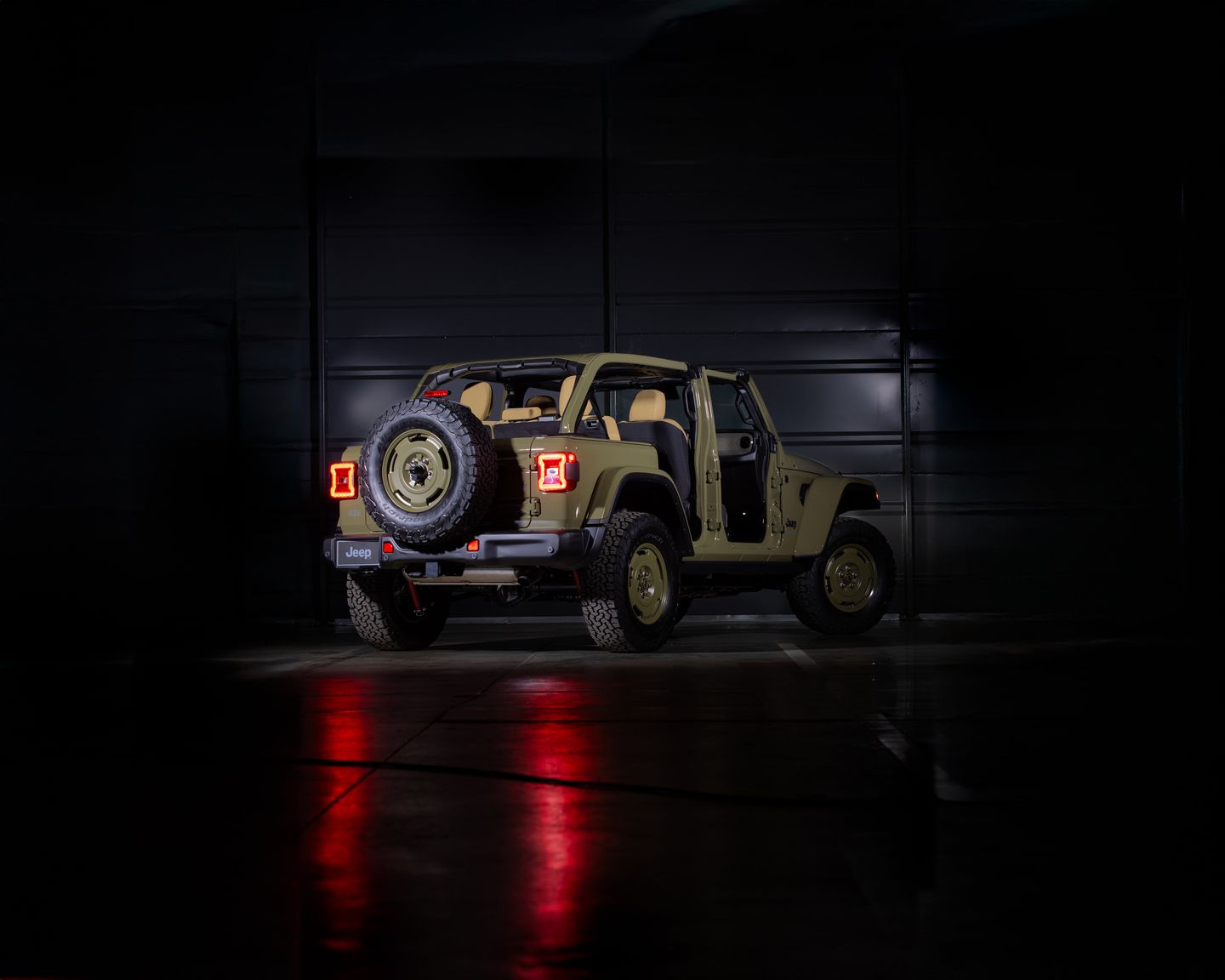 2026 Jeep Wrangler 4xe - a rear view of an olive green 2026 Jeep Wrangler 4xe with no doors in a studio - Cooksville Dodge, Chrysler, Jeep, RAM - New car dealership in Mississauga, Ontario