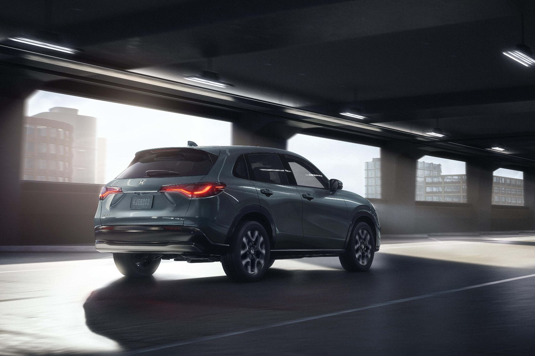 2026 Honda HR-V - Rear three-quarter view of a dark green Honda HR-V driving in a tunnel - Goderich Honda - New car dealership in Goderich, Ontario