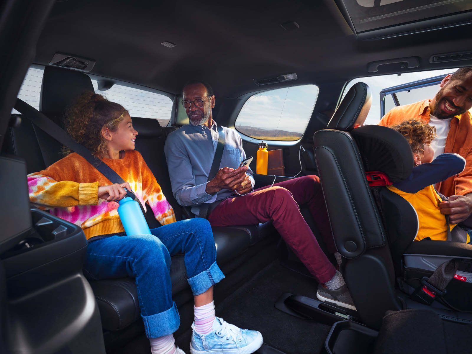 2026 Toyota Grand Highlander - A family sitting comfortably in the spacious third-row seating of the 2026 Toyota Grand Highlander - Orangeville Toyota - Toyota new car dealership in Orangeville, Ontario