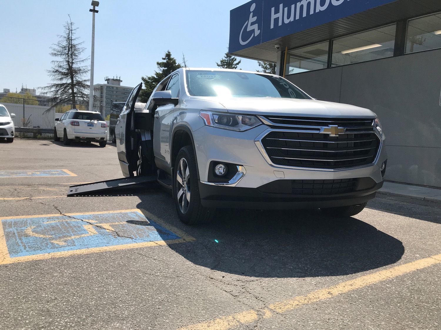 Chevrolet Traverse - Front-side view with the wheelchair ramp extended - Humberview Mobility - Accessible vehicle dealership in Toronto, On