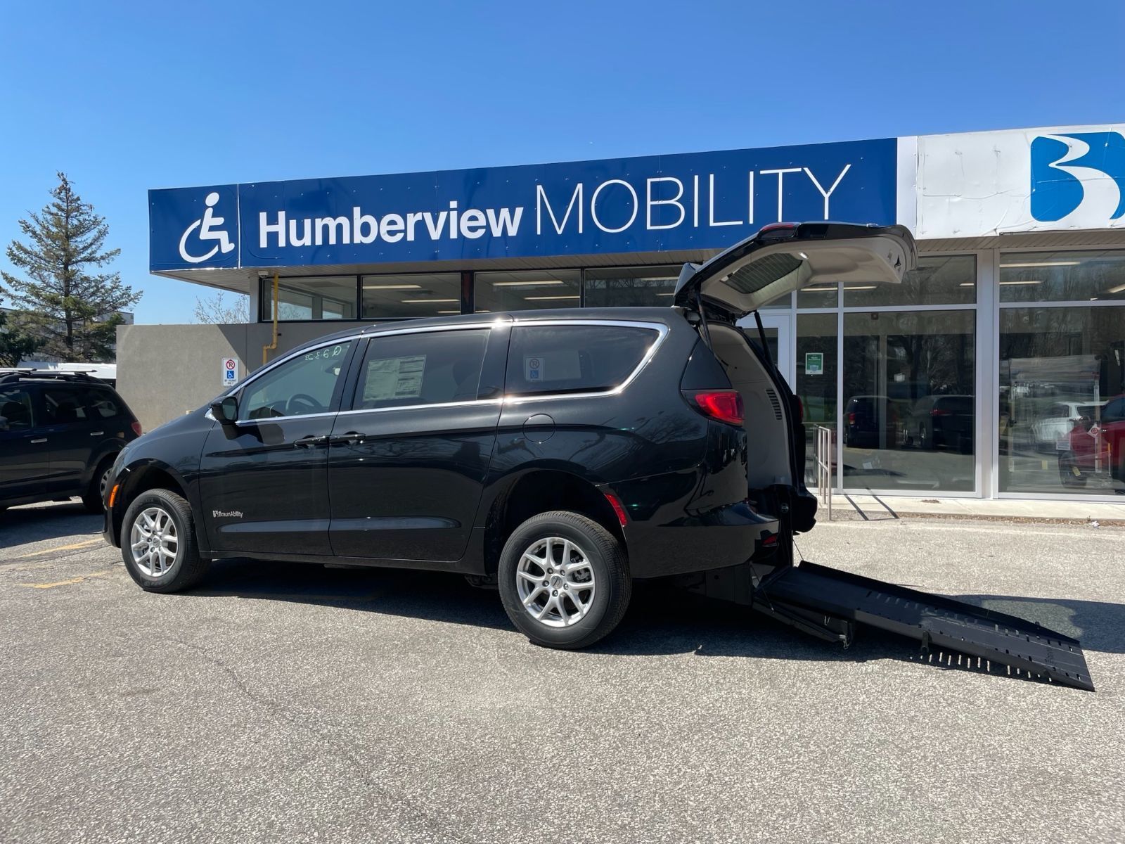 Chrysler Grand Caravan - Side view of the rear-entry conversion with the ramp deployed - Humberview Mobility - Accessible vehicle dealership in Toronto, On