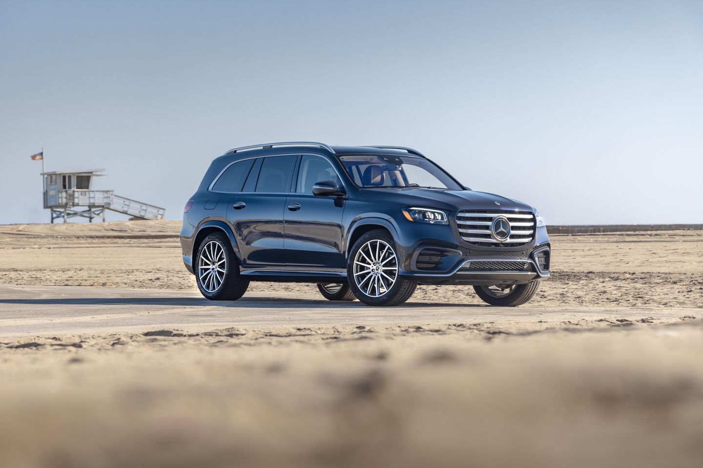2026 Mercedes-Benz GLS - A dark blue 2026 Mercedes-Benz GLS parked on a sandy beach - Mercedes-Benz Brampton - New car dealership in Brampton, Ontario