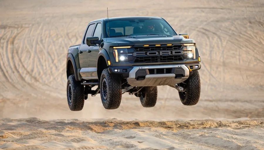 2026 Ford F-150 Raptor - A 2026 Ford F-150 Raptor captured mid-air while jumping in a sandy area - Mayfield Ford - New car dealership in Brampton, Ontario