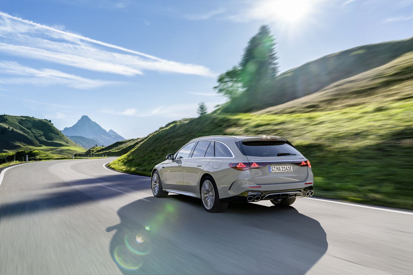 2026 Mercedes-AMG E 53 Wagon - Rear view of the silver wagon driving on a scenic mountain road - Mercedes-Benz Brampton - New car dealership in Brampton, Ontario