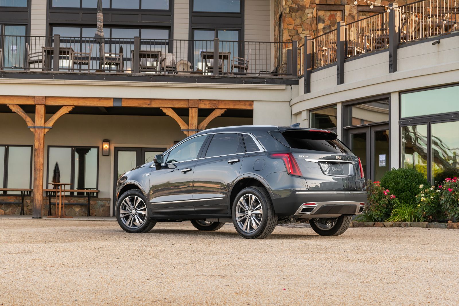 2026 Cadillac XT5 - rear angle view of a dark grey Cadillac XT5 parked outdoors - Applewood Cadillac - New car dealership in Mississauga, Ontario