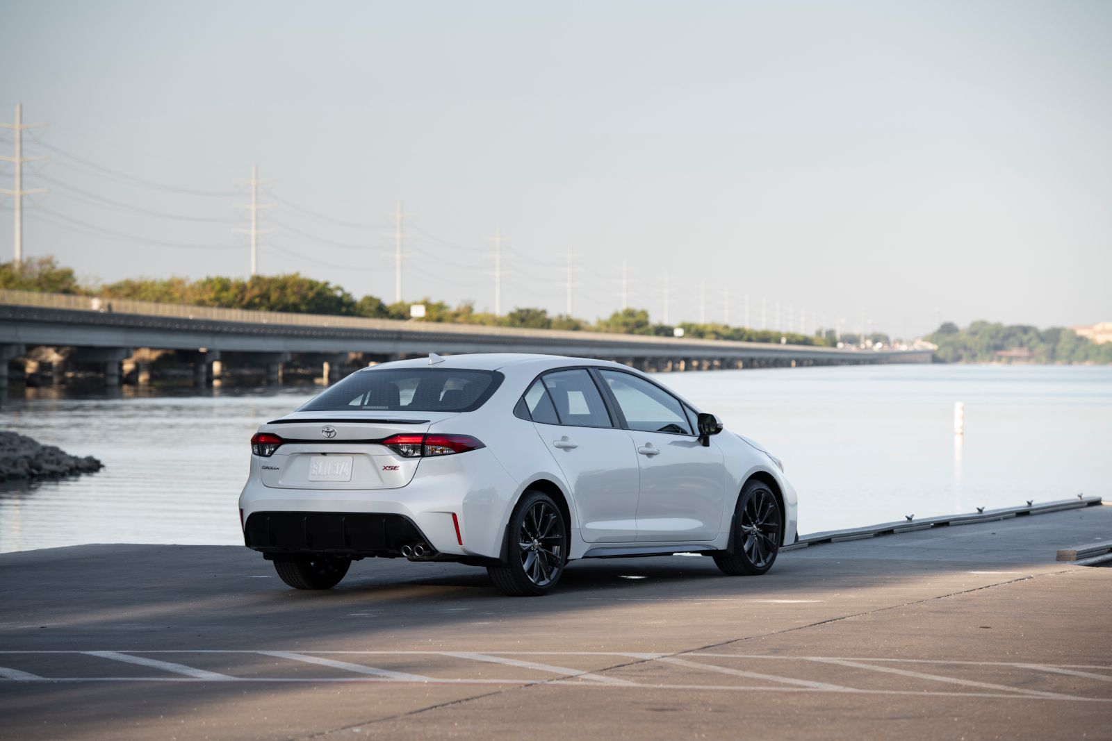 2026 Toyota Corolla - rear view of a white 2026 Toyota Corolla XSE sedan parked by the water - Goderich Toyota - Toyota new car dealership in Goderich, Ontario