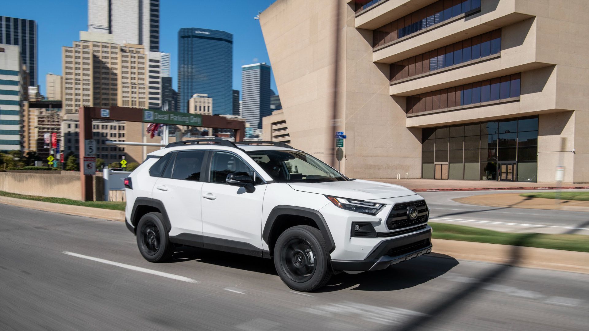 Toyota RAV4 - White Toyota RAV4 driving on a city street - AutoPark Barrie - Pre-owned car dealership in Innisfil, Ontario