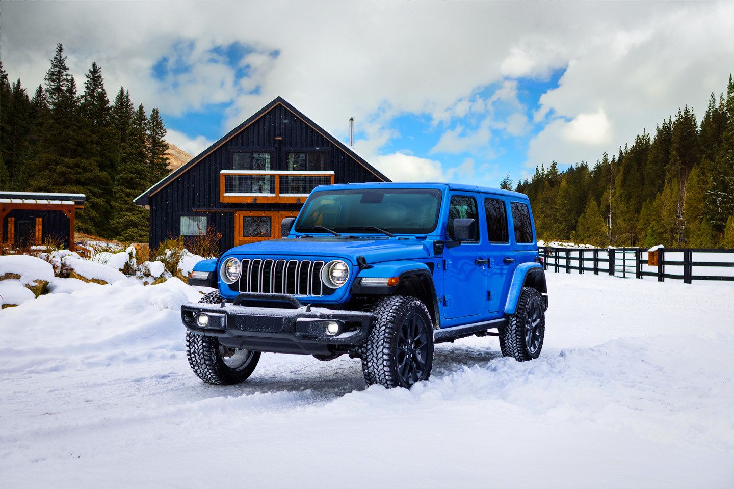 Jeep Wrangler - Blue Jeep Wrangler parked in the snow - AutoPark Barrie - Pre-owned car dealership in Innisfil, Ontario