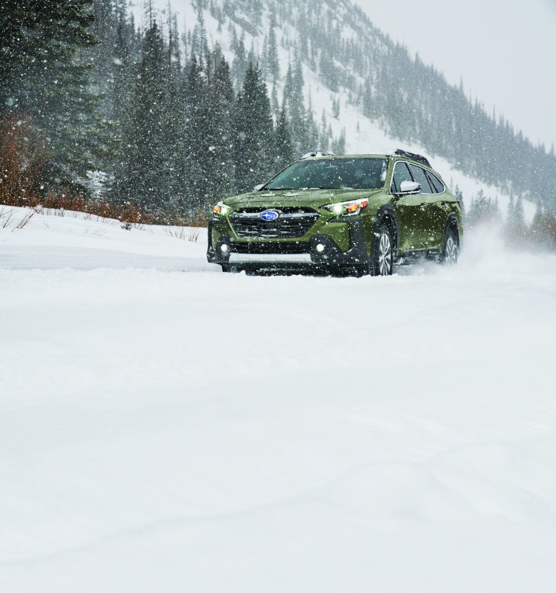 Subaru Outback - a green Subaru Outback driving on a snowy road - AutoPark Brampton - Pre-owned car dealership in Brampton, Ontario
