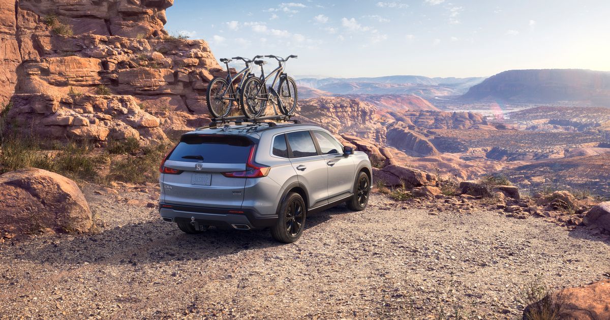 Honda CR-V - a silver Honda CR-V carrying bicycles on a roof rack in a desert landscape - AutoPark Brampton - Pre-owned car dealership in Brampton, Ontario