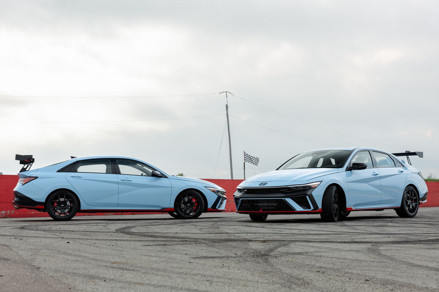 2026 Hyundai Elantra N TCR - two Performance Blue 2026 Hyundai Elantra N TCR sedans parked on a track - Cooksville Hyundai - New car dealership in Mississauga, Ontario