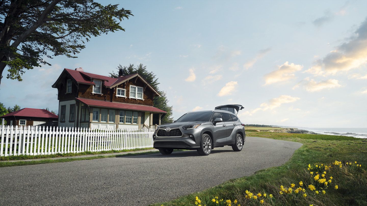 2026 Toyota Highlander - a grey 2026 Toyota Highlander parked on a coastal road with the rear hatch open - Humberview Group - New car dealerships in Ontario