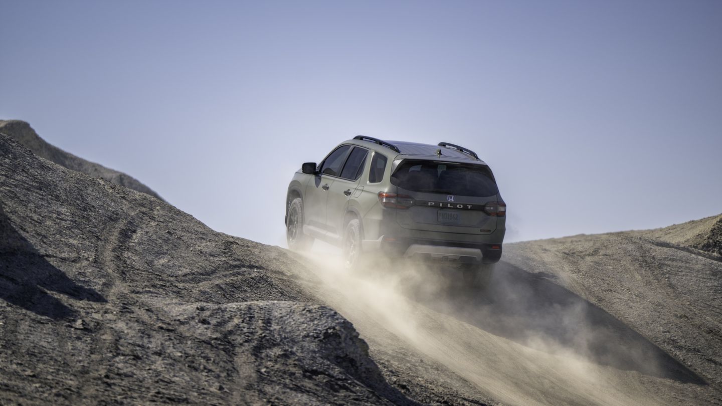 2026 Honda Pilot TrailSport - a green Honda Pilot TrailSport driving on a dusty desert trail - Goderich Honda - New car dealership in Goderich, Ontario