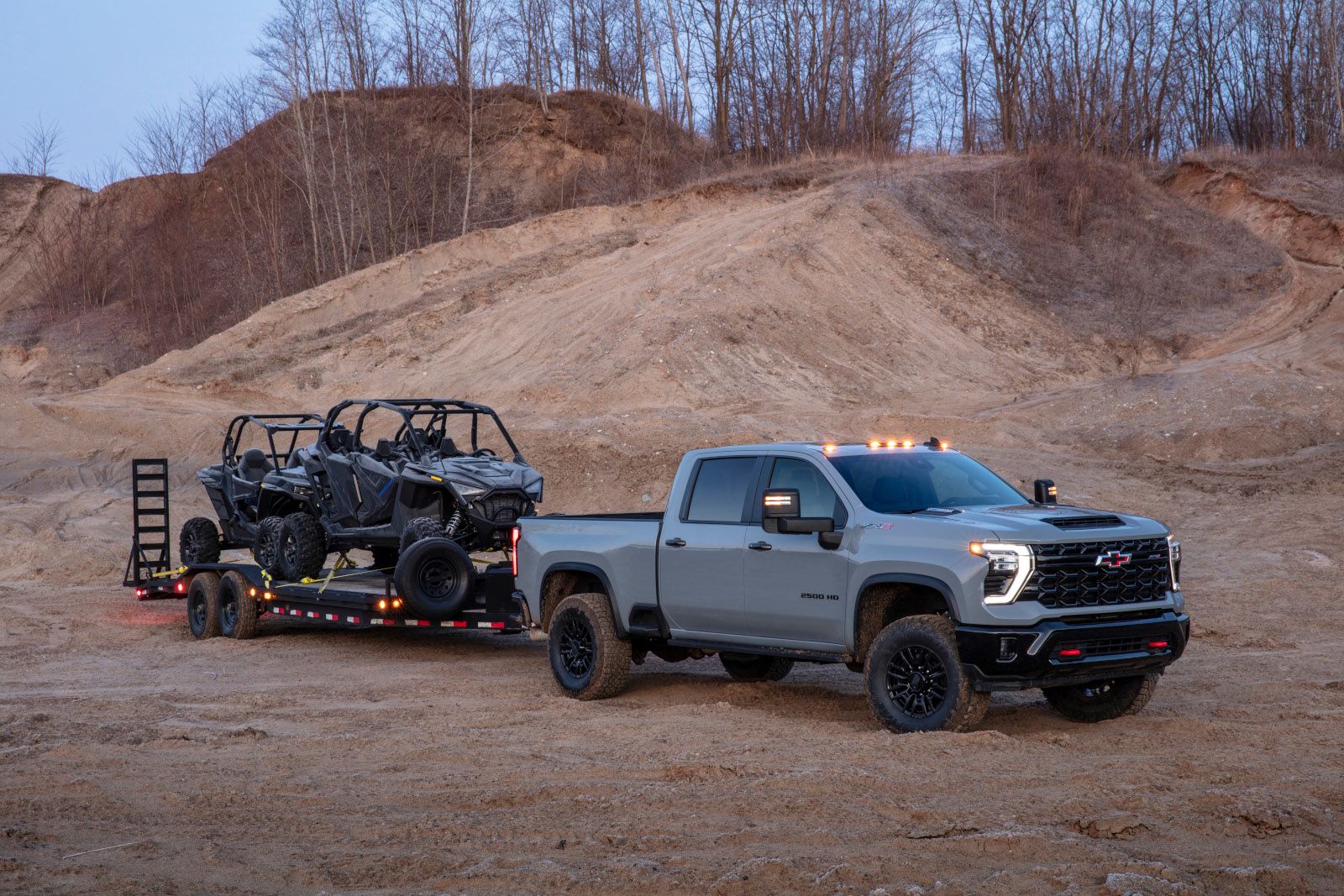 2026 Chevrolet Silverado HD ZR2 - a grey Chevrolet Silverado HD ZR2 towing a trailer with two UTVs - Humberview Chevrolet - New car dealership in Toronto, Ontario