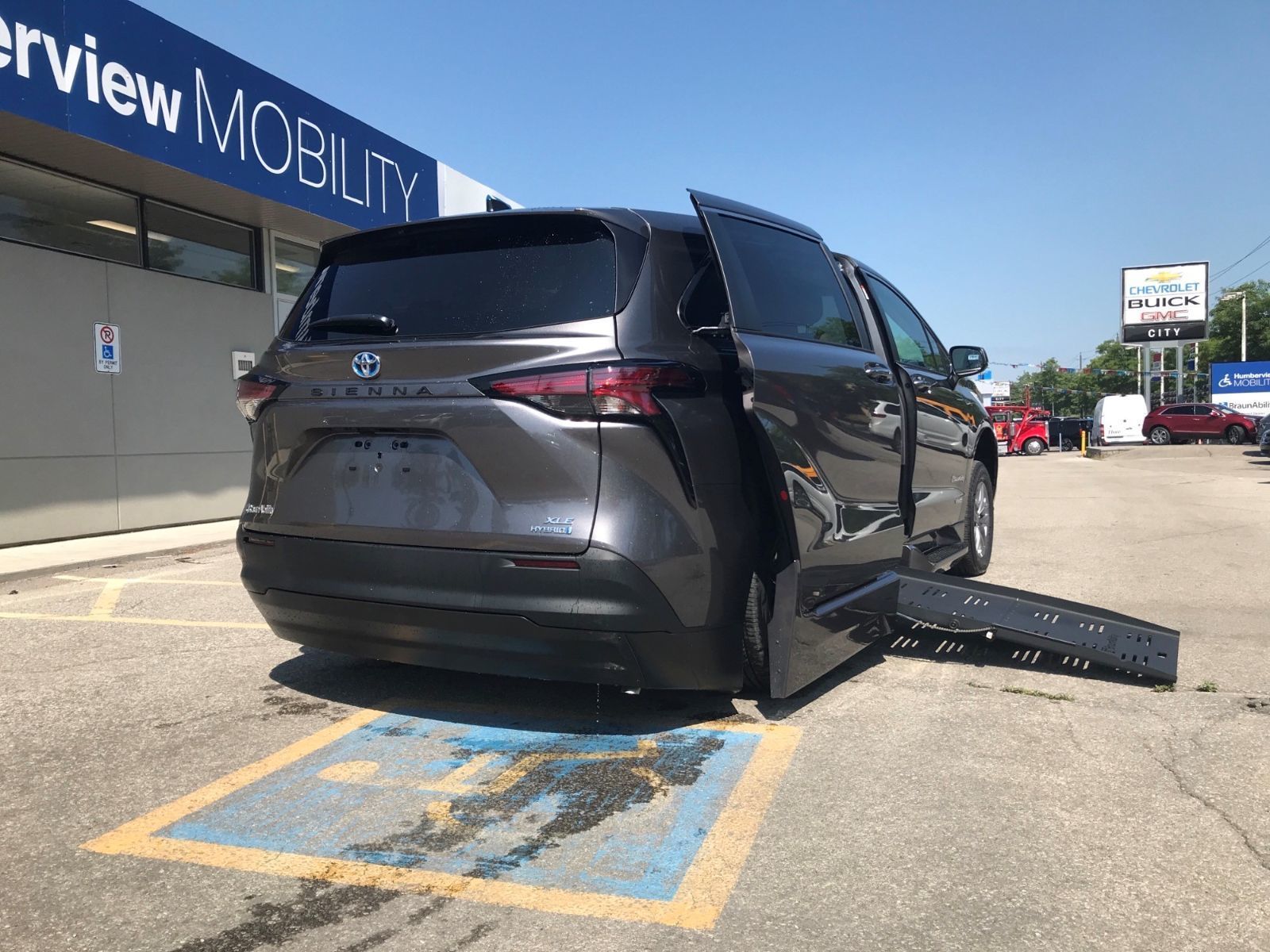 2026 Toyota Sienna - rear view of a grey 2026 Toyota Sienna with the rear-entry wheelchair ramp deployed - Courtland Mobility - Accessible car dealership in Burlington, Ontario