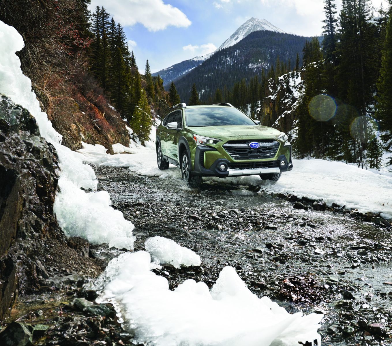 2026 Subaru Outback - a green 2026 Subaru Outback driving through melting snow on a mountain trail - AutoPark Barrie - Accessible car dealership in Barrie, Ontario