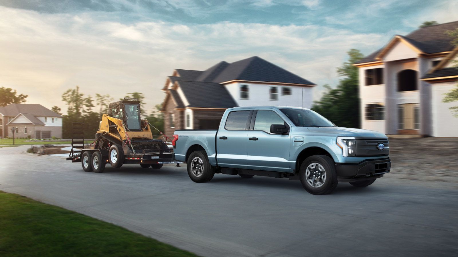 2026 Ford F-150 Lightning - A light blue Ford F-150 Lightning towing a construction trailer - Mayfield Ford - New car dealership in Brampton, Ontario