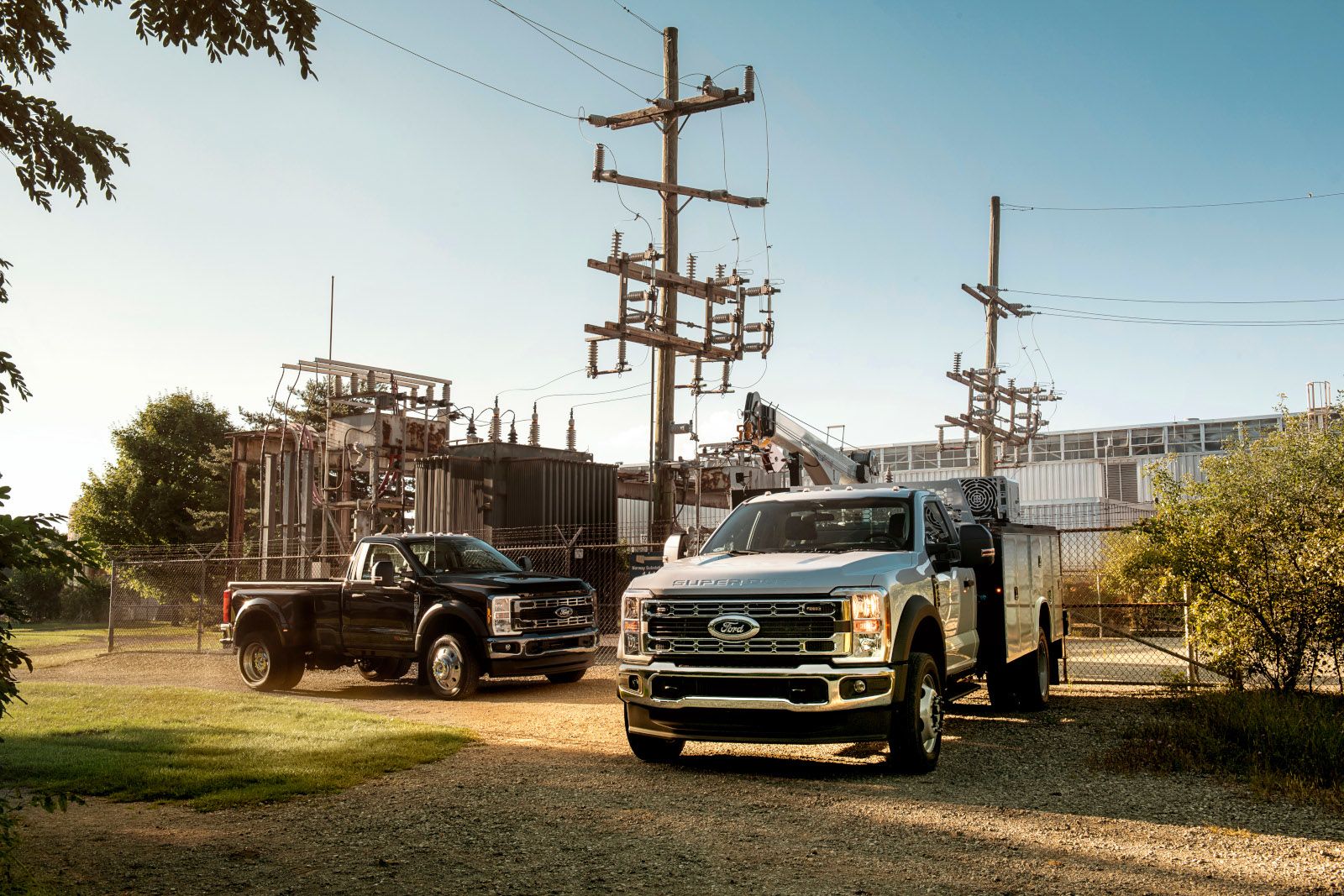 2026 Ford Super Duty - two 2026 Ford Super Duty Chassis Cab trucks parked in an industrial area - Bayfield Ford - New car dealership in Barrie, Ontario